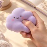 Illustrative hand squeezing a lavender cloud squishy
