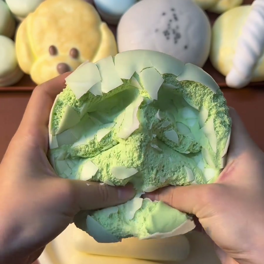 Green Steamed Bun Crackle Squishy — close-up during pressing