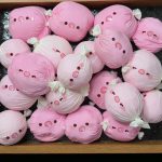 A tray of pink pig candy-shaped squishy toys