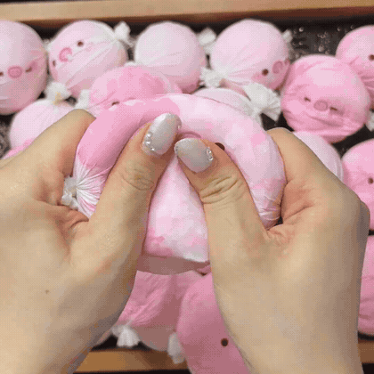 Pink pig candy squishy being squeezed — animated product demonstration